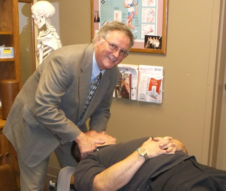 A chiropractor does a neck adjustment to help with a patient's neck pain.
